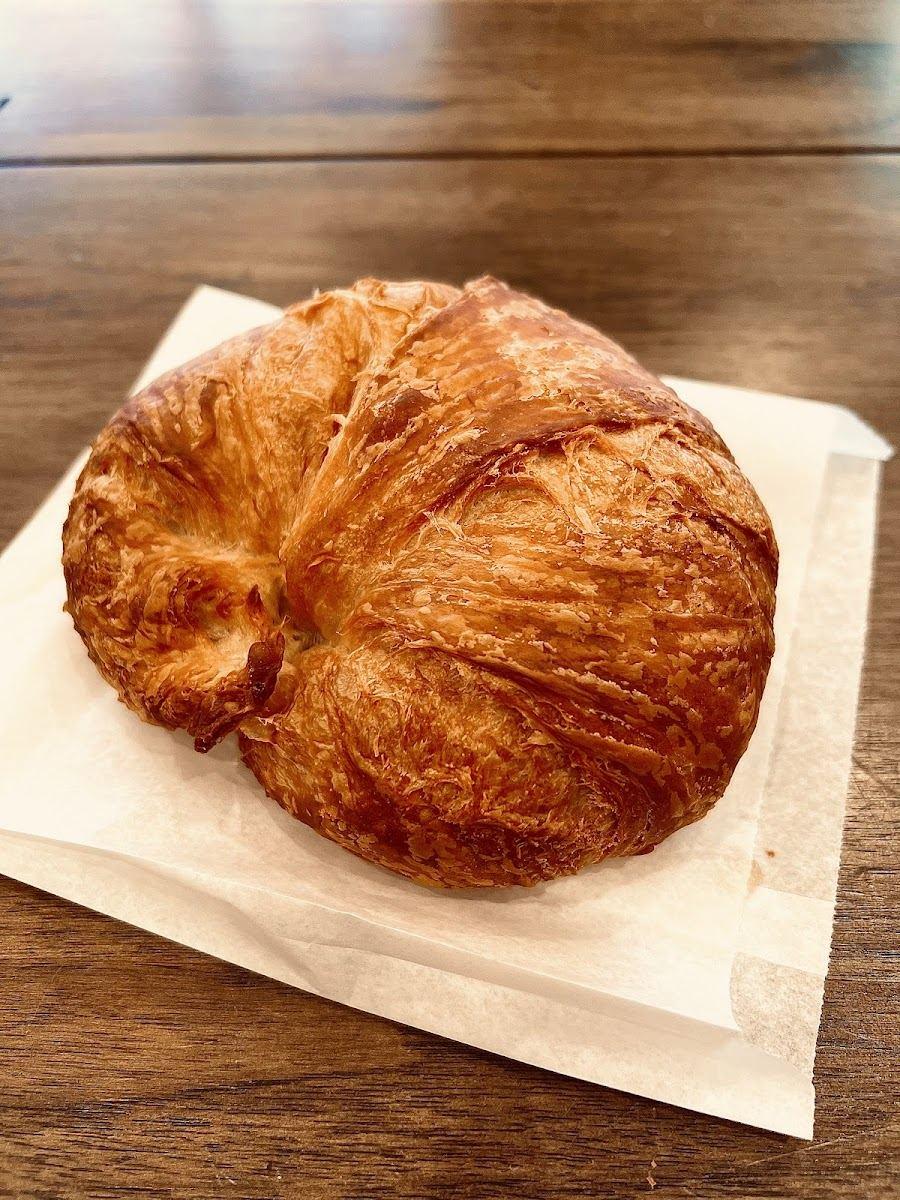 A butter croissant on parchment